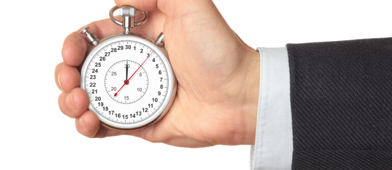 tracking indirect time in timesheet with indirect cost pools- man's hand in suit sleeve with stopwatch